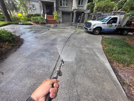Technician performing driveway washing in fernandina beach fl